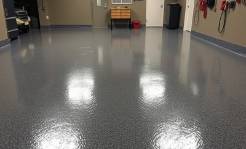 Stunning metallic-epoxy garage floor with night reflections.
